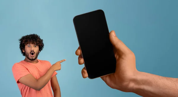 Shocked Young Indian Man Pointing Blank Smartphone Huge Hand Giant — Stockfoto