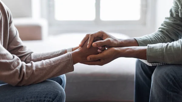 Cropped of black man psychologist holding hands of woman patient provide professional aid psychological help close up, show support express empathy concept, web-banner design, panorama