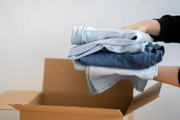 Closeup Shot Woman Packing Stack Clothes Cardboard Box Unrecognizable Female — Stock Photo, Image