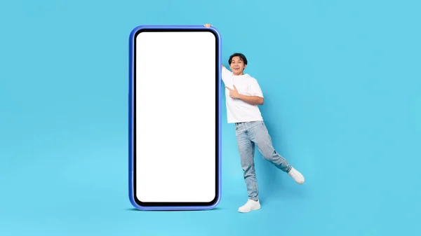 Cheerful Japanese Male Teen Posing Big Cellphone Empty Screen Pointing — 스톡 사진