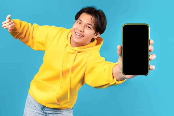 Cheerful Asian Teenager Boy Showing His Smartphone Blank Screen Recommending — 스톡 사진