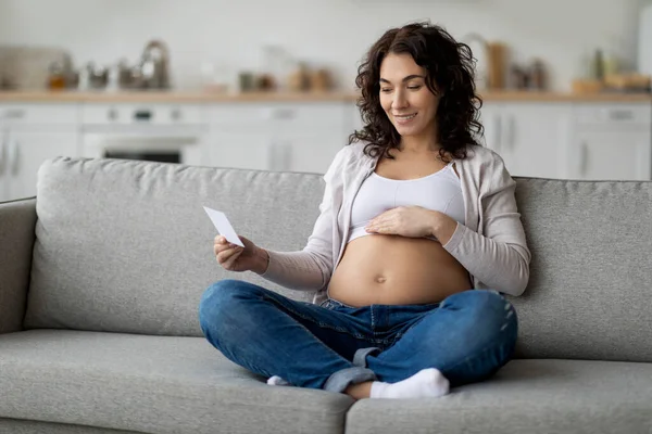 Smiling Pregnant Woman Embracing Belly Looking Her Baby Sonography Image — Foto Stock