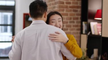 True love and romance. Happy asian couple in love dancing at home and laughing, celebrating anniversary, enjoying romantic moment, tracking shot, slow motion