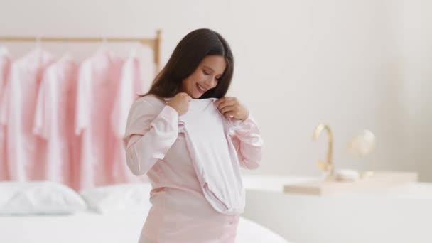 Young Happy Pregnant Woman Anticipating Her Motherhood Trying Cute Tiny — 图库视频影像