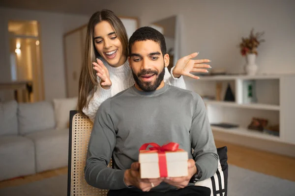Smiling Millennial European Female Opens Eyes Hands Arab Husband Gives — Stock Photo, Image