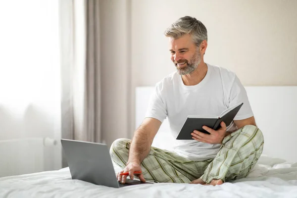 Cheerful Positive Handsome Grey Haired Mature Man Wearing Pajamas Sitting — Stock Photo, Image