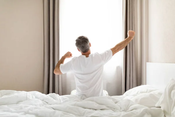 Rear View Unrecognizable Middle Aged Man Pajamas Sitting Bed Stretching — Stock Photo, Image