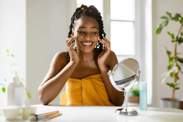 Pflegekonzept Afroamerikanerin Die Hause Gesichtscreme Auf Die Wangen Aufträgt Den — Stockfoto