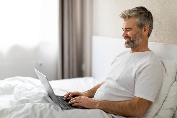 Relaxado Feliz Bonito Homem Meia Idade Vestindo Pijama Usando Laptop — Fotografia de Stock