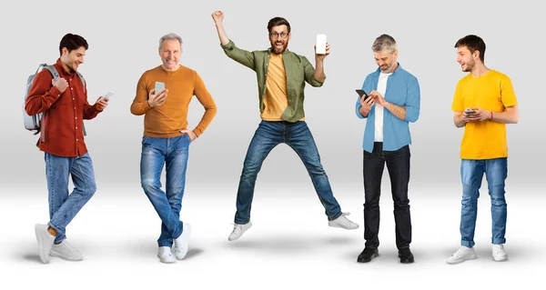 Χαρούμενα Συναισθηματική Νέους Και Ενήλικες Άνδρες Casual Jumping Πληκτρολογώντας Smartphone — Φωτογραφία Αρχείου
