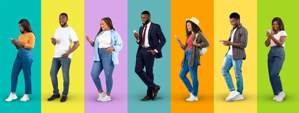 Smiling young black people in casual and suit typing on smartphones, internet surfing isolated on colorful background, studio, panorama. Communication and chat, social media technology, blog and app