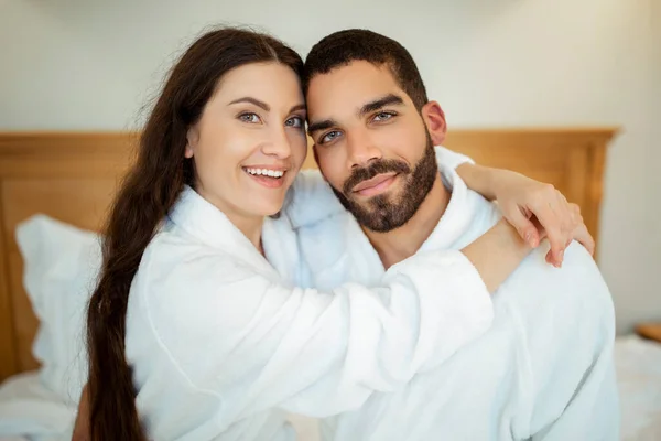 Loving Couple Hugging Wearing White Bathrobes Posing Sitting Bedroom Indoors — Stock Photo, Image