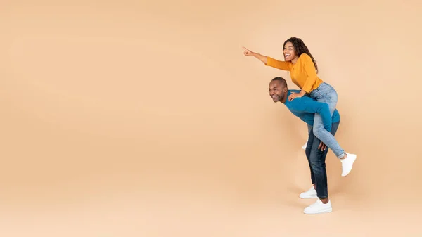 Mujer Negra Feliz Apoyando Marido Señalando Espacio Libre Hombre Mediana —  Fotos de Stock
