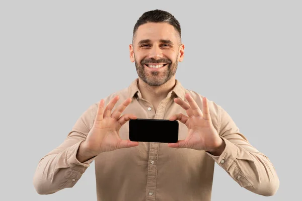 Счастливый Мужчина Средних Лет Показывает Смартфон Чистым Экраном Рекламу Сайт — стоковое фото