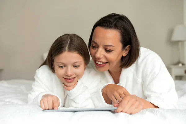 Cheerful European Millennial Woman Little Girl Bathrobes Watch Video Tablet — Stock Photo, Image