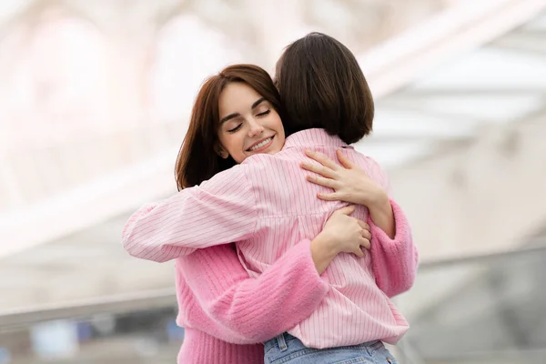 Mujer Joven Feliz Abrazando Amiga Aeropuerto Hall Primer Plano Dos — Foto de Stock