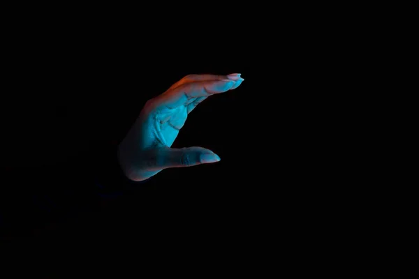 Black female hand holding invisible object, showing small amount of something or holding something, black background with neon lights. Panorama with copy space