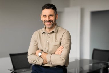 Ofis şirketinde duran, kollarını kavuşturup kameraya gülümseyen, bedava fotokopi çeken profesyonel patron liderinin portresi. Başarılı bir iş adamı.