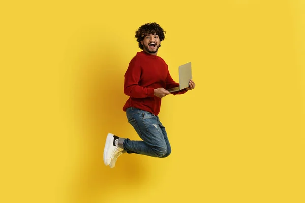 Happy Young Stylish Indian Man Jumping Air Laptop His Hand — Stock Photo, Image