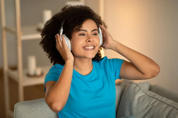 Usmívající Tisíciletá Africká Kudrnatá Žena Bezdrátových Sluchátkách Poslouchá Hudbu Užívá — Stock fotografie