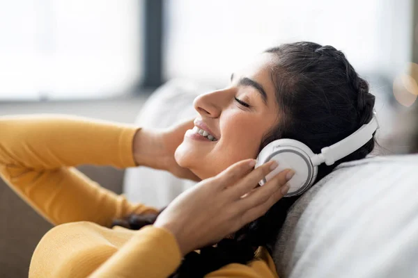 Smiling Young Indian Woman Wearing Wireless Headphone Listening Music Home — 스톡 사진