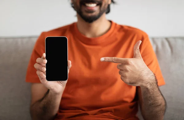 Jsem Rád Mladý Muž Středního Východu Gauči Ukazuje Prstem Smartphone — Stock fotografie