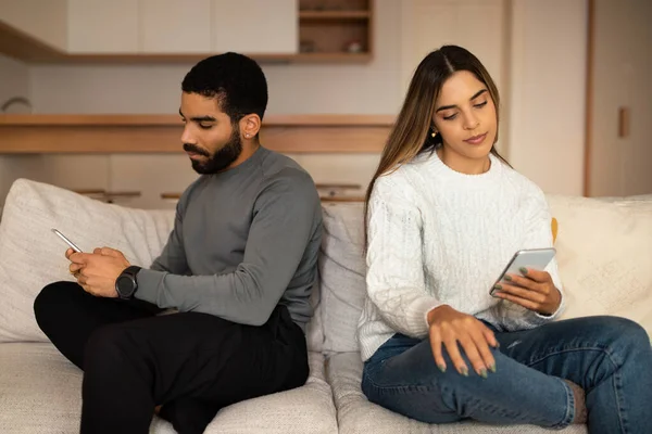 Sad Offended Millennial Arab Husband Ignoring Caucasian Wife Look Smartphone — Stock Photo, Image