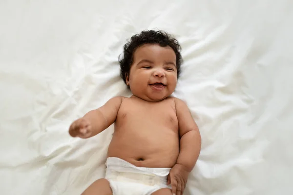 Rindo Bonito Afro Americano Pequeno Bebê Encaracolado Fralda Encontra Cama — Fotografia de Stock