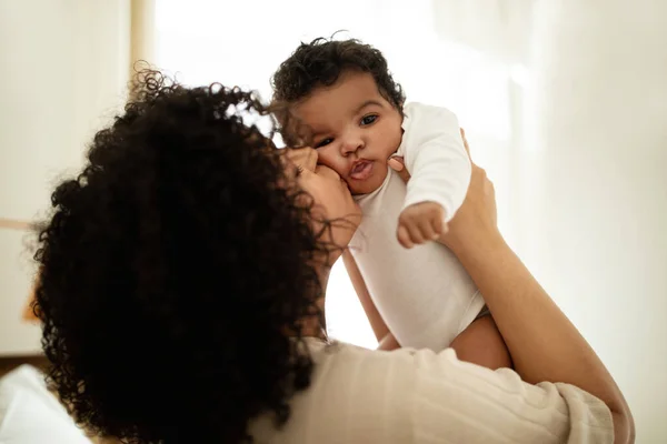 Happy Millennial African American Mother Kissing Little Child Enjoy Relax — Stock Photo, Image