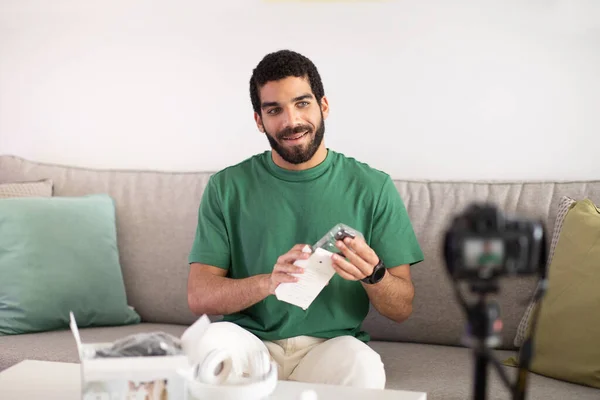 Cheerful Young Middle Eastern Man Blogger Shows Headphones Shooting Video — Stock Photo, Image