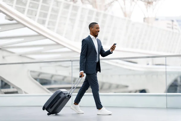 Handsome Black Businessman Walking Suitcase Airport Using Smartphone Young African — Stock Photo, Image