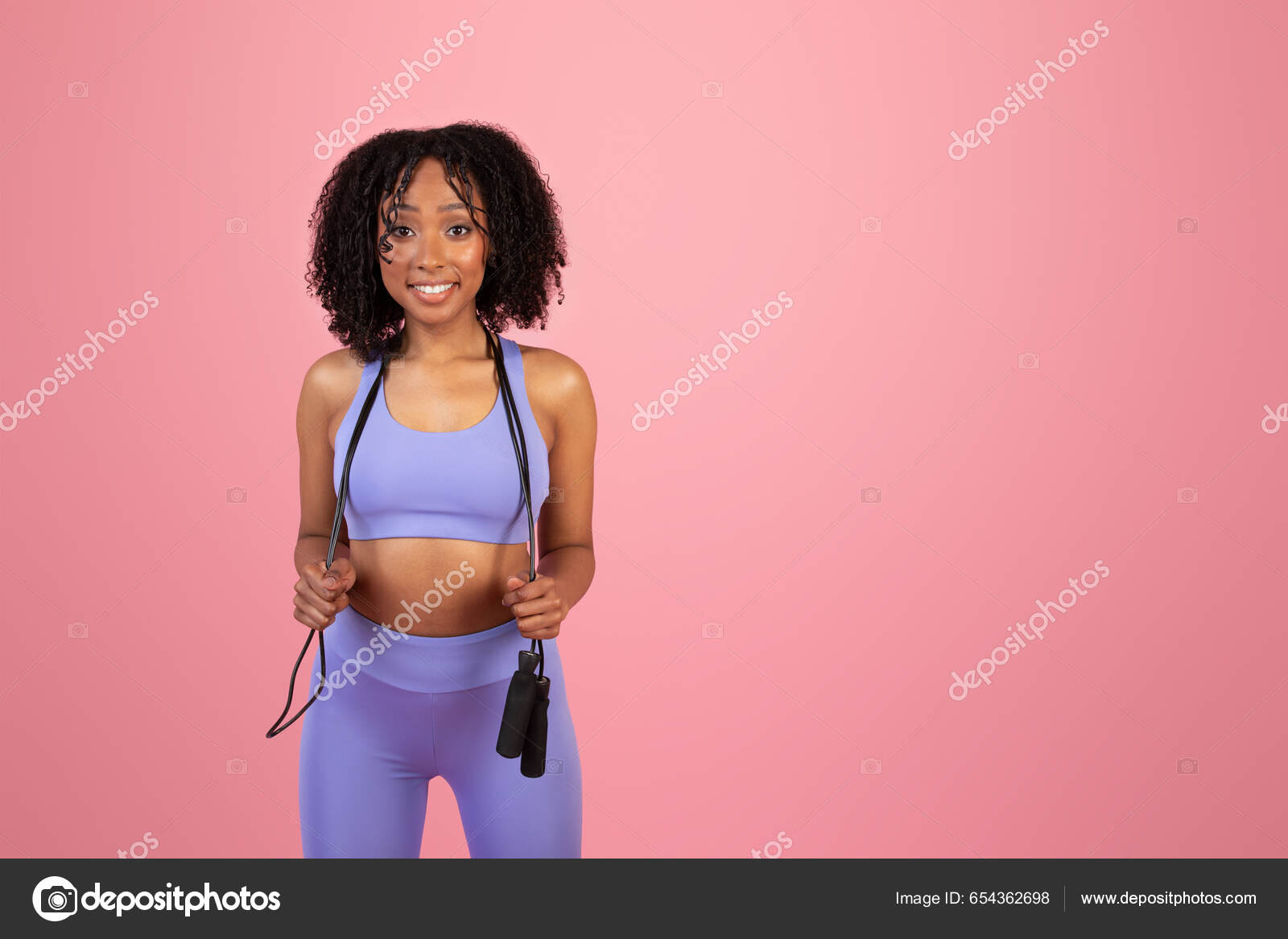 Smiling Young African American Curly Lady Sportswear Hold Jump