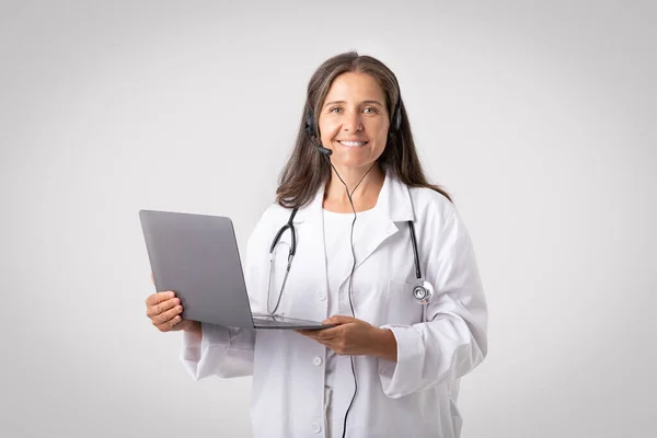 Telemedicine Consultations Senior Woman Doctor Conducting Remote Consultations Patients Using — Stock Photo, Image