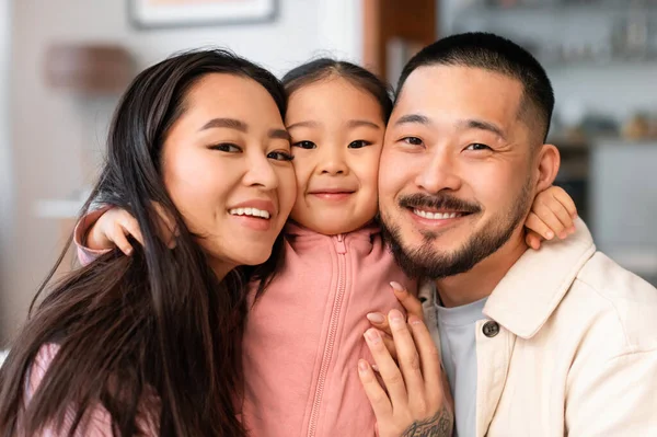 Embracing Love Portrait Happy Asian Parents Hugging Little Daughter Smiling — Stock Photo, Image