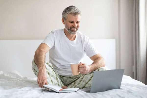 Relaxed Cheerful Handsome Middle Aged Man Wearing Pajamas Planning Vacation — Stock Photo, Image