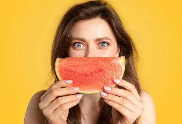 Summertime. Portrait of joyful lady having fun and posing with juicy watermelon near face, standing on yellow studio background, banner. Summer fresh fruits