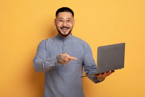 Handsome Young Asian Man Pointing Laptop His Hands Happy Millennial — стокове фото