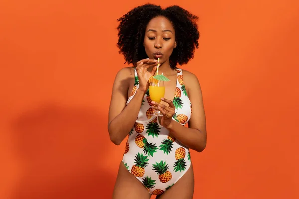 Vrolijke Grappige Jonge Zwarte Vrouw Kleurrijke Eendelige Badpak Drinken Oranje — Stockfoto