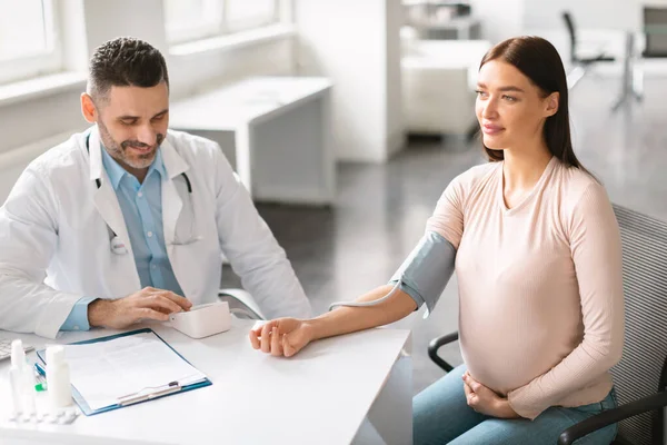 Cheerful Male Gynecologist Measuring Blood Pressure Young Pregnant Patient Checkup — Stock Photo, Image
