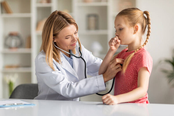 Pediatrician Lady With Stethoscope Listening Lungs Of Coughing Little Girl During Checkup, Professional Pediatrist Doctor Woman Checking Health Condition Of Sick Female Child, Closeup Shot
