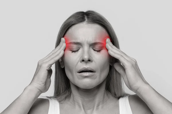 偏头痛的概念 中年妇女头痛 太阳穴红肿 情绪激动 黑白照片 背景隔离 特写镜头 — 图库照片