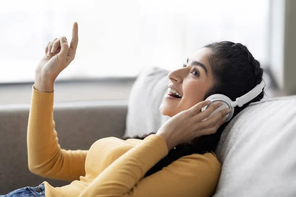 Wearing Wireless Headphone Relaxing Home Smiling Eastern Woman Listening Music — 스톡 사진