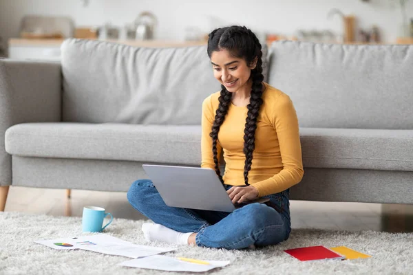 stock image Happy Indian Freelancer Woman Working With Laptop And Papers At Home, Smiling Young Eastern Female Sitting On Floor In Room And Typing On Computer, Enjoying Remote Online Work, Copy Space