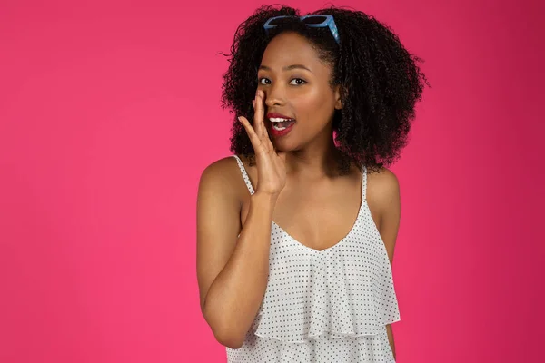 Positive Pretty Young Black Curly Woman Tells Secret Isolated Pink — Stock Photo, Image