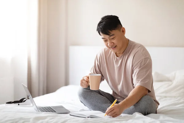 Positive Happy Middle Aged Chinese Man Wearing Pajamas Planning Vacation — Stock Photo, Image