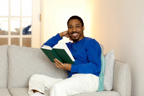 Love Reading Cheerful African American Guy Reads Paperback Book Smiling Stock Picture