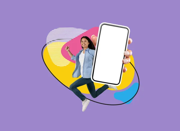 新しいアプリだ カラフルな抽象的な背景を飛び越えながら大きなブランクスクリーンを持つ幸せなアジアの女性 陽気韓国の女性は モバイルアプリケーションをお勧めします モックアップ — ストック写真