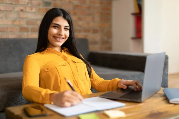Cheerful Spanish Lady Studying Online Laptop Home Taking Notes Remote — Stock Photo, Image