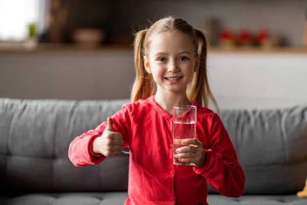 Portrait Cute Little Girl Holding Glass Water Showing Thumb Happy — Stok Foto