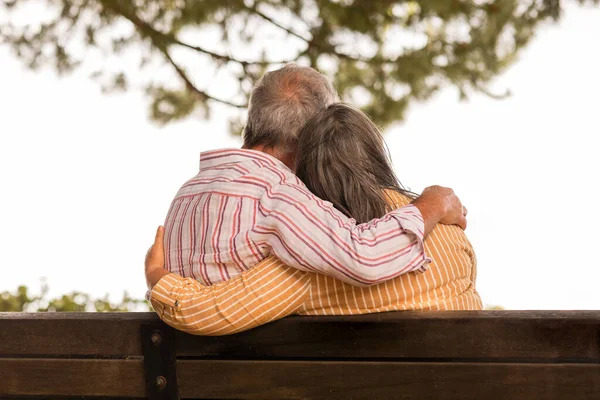 Senior Caucasian Wife Hugging Husband Sitting Bench Rest Relax Park — Stock Photo, Image
